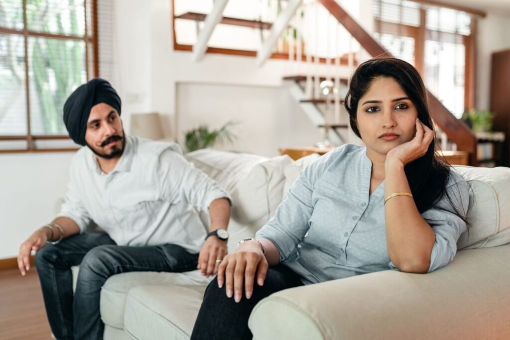 Love & Relationship Astrology in Mumbai: Couple sitting apart on a sofa after an argument